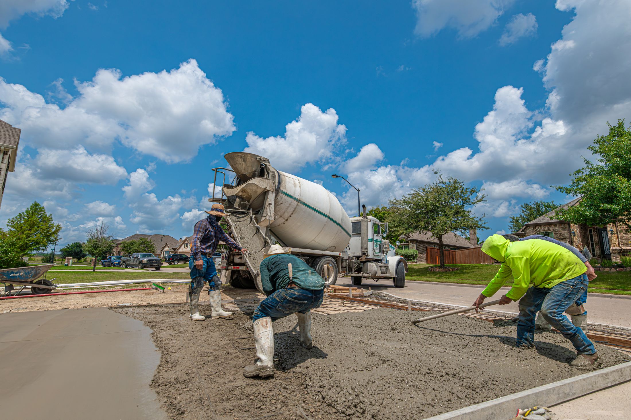 Concrete crew placing and leveling a residential slab