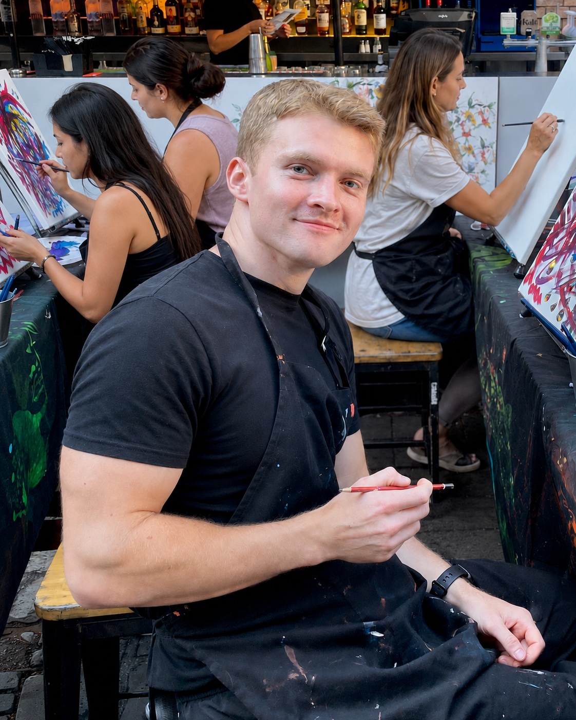 Luke Weber painting at an outdoor studio