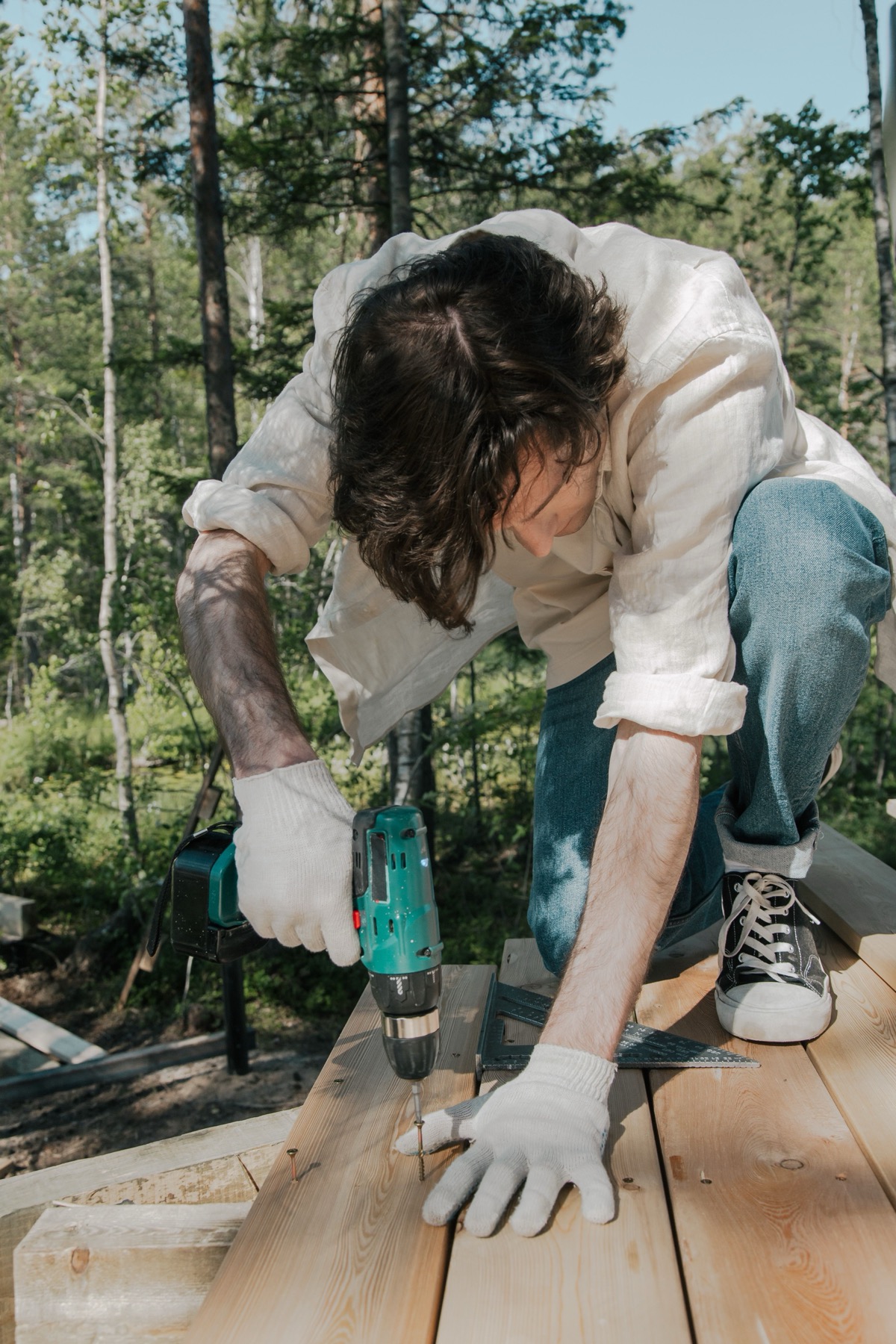 Carpenter drilling into a newly built outdoor deck