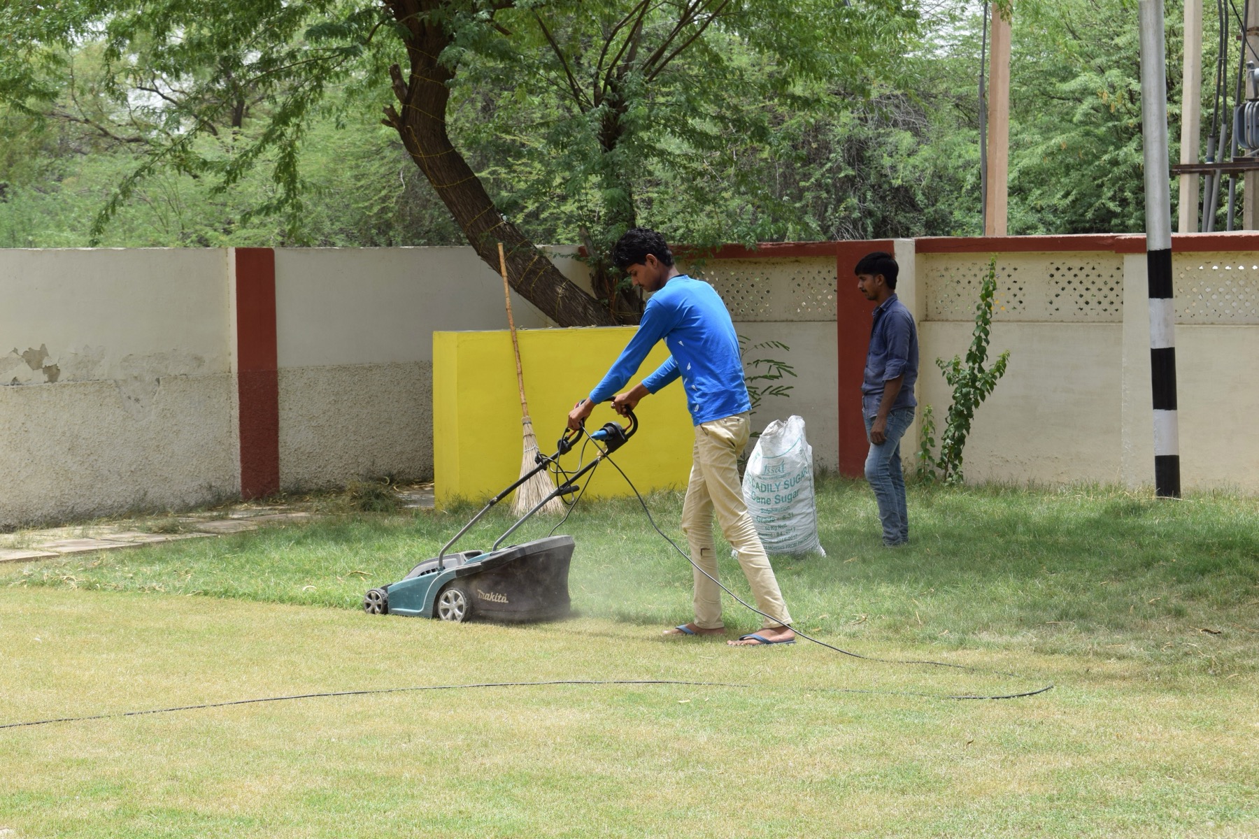 Landscaping crew mowing a residential lawn