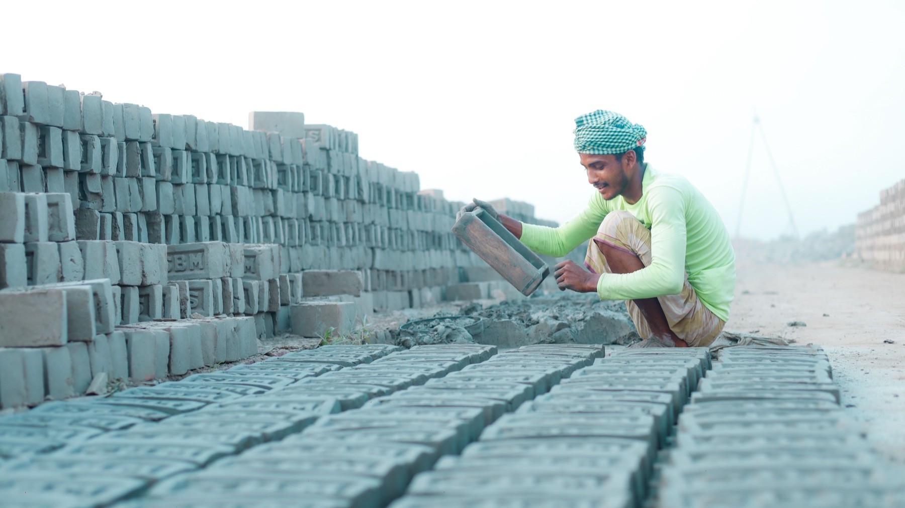 Mason laying bricks on an outdoor construction project